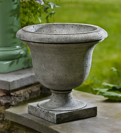 Small empty urn shown next to green column