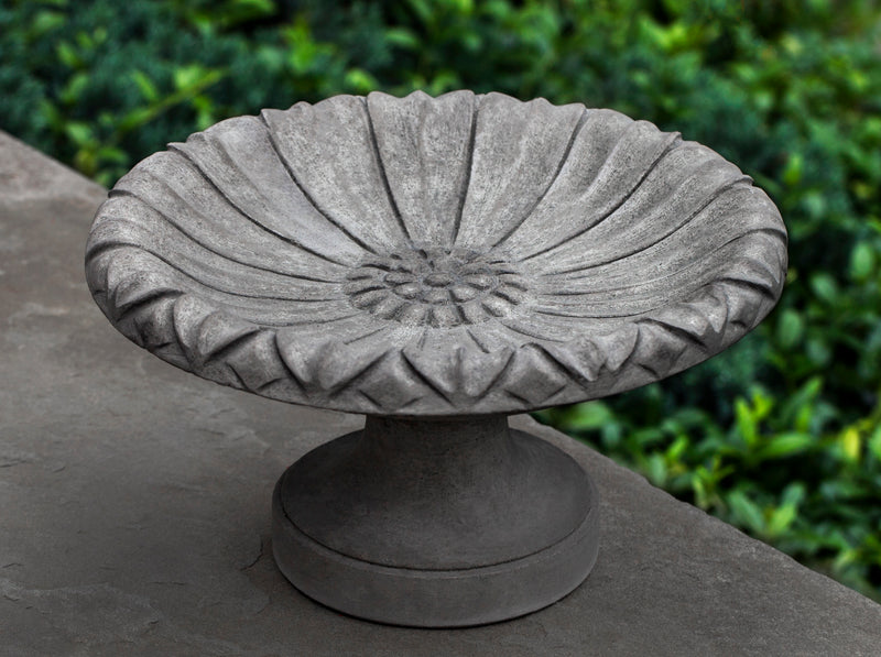 Small round gray birdbath with flower etching in bowl
