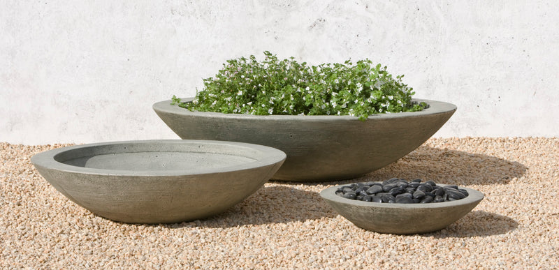 Grouping of 3 low bowls shown on gravel