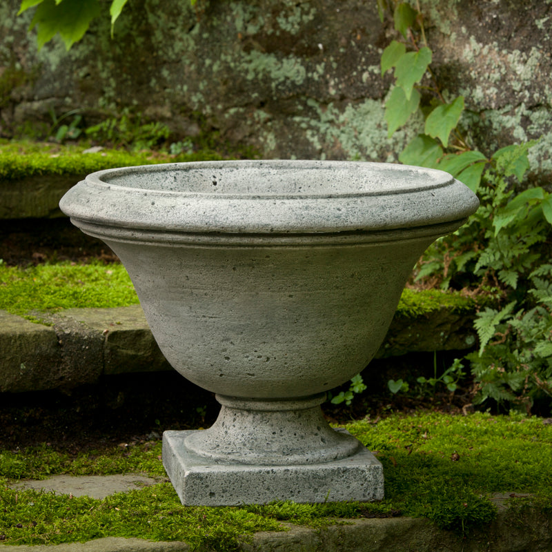 Grey urn shown on mossy steps