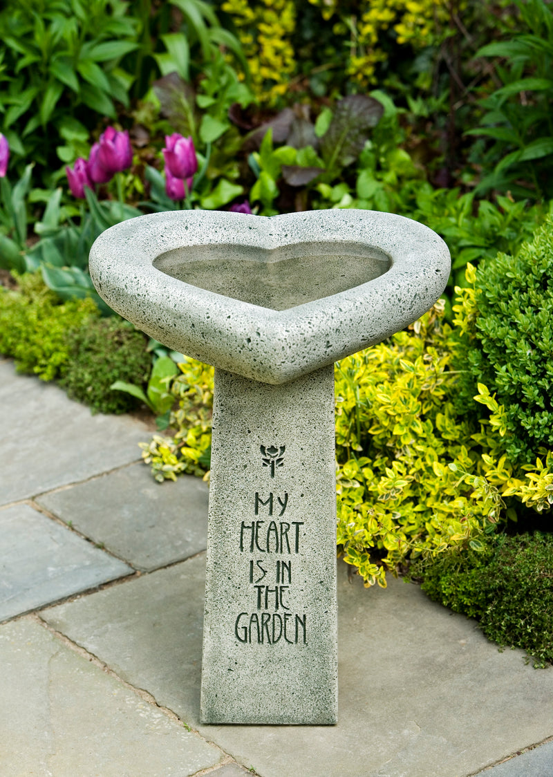 Heart shaped bowl on top of square pedestal with My Heart is in the Garden carving