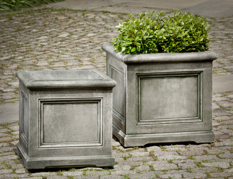 Set of 2 square containers on top of stone pavers