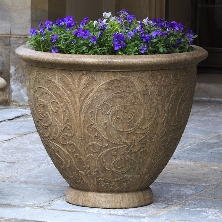 Light brown planter with arabesque designs shown planted with pansies