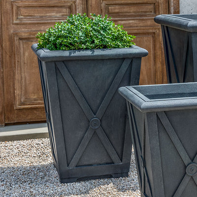 Grouping of 3 slate grey containers shown in front of wooden door