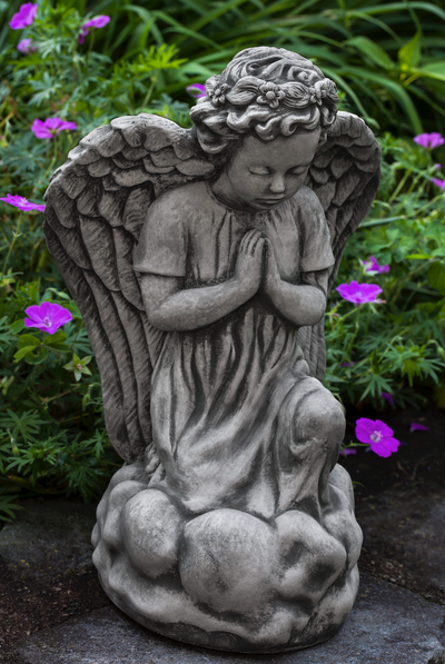 Kneeling praying angel with large wings