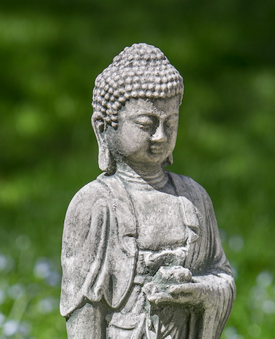 Close up of the top half of a standing buddha holding a small container