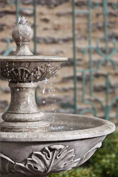 Close up of two-tiered fountain top with acanthus design on exterior of both bowls