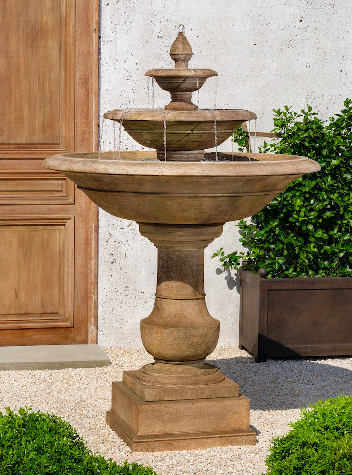 Brown tiered classic fountain with three bowls pictured in front of door
