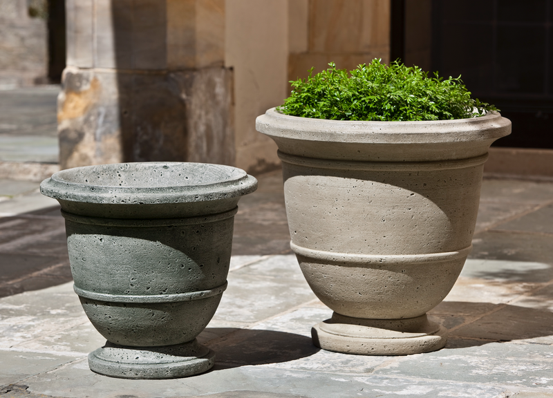 Set of 2 urns shown on stone flooring
