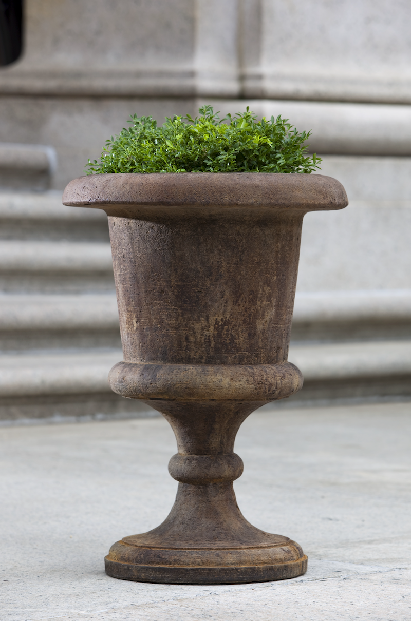 Classic goblet urn planted with greenery in front of steps