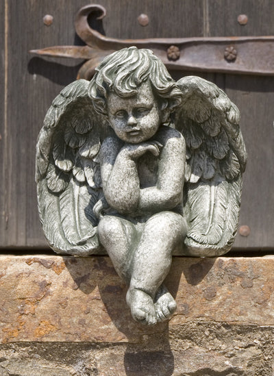 Sitting cherub with crossed legs and spread wings