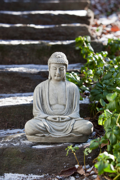 Light gray buddha sitting on steps