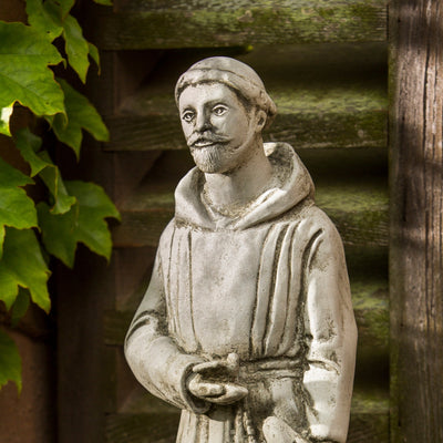 Close up of St Francis in front of mossy steps
