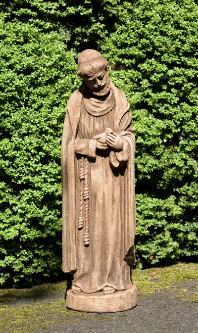 Saint Francis standing on small plinth and holding a bird