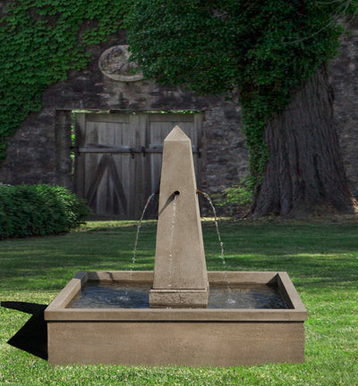 Brown fountain with square basin and obelisk column with four copper spouts