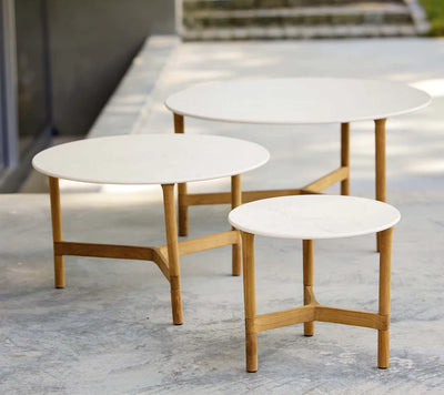 Three white coffee tables in different sizes on terrace