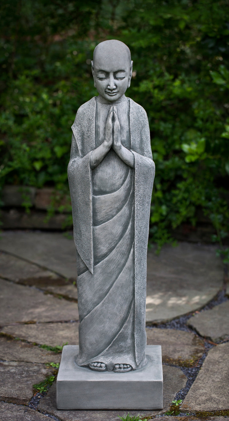 Standing buddha in draped robe praying