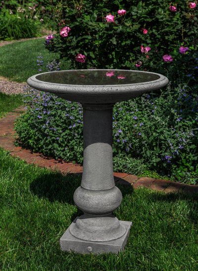 Classic gray birdbath with round bowl and boxwood detail on the pedestal bottom