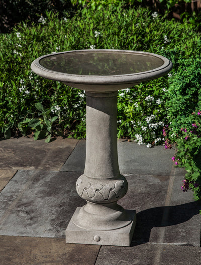 Gray birdbath with round bowl and knot design on bottom of pedestal