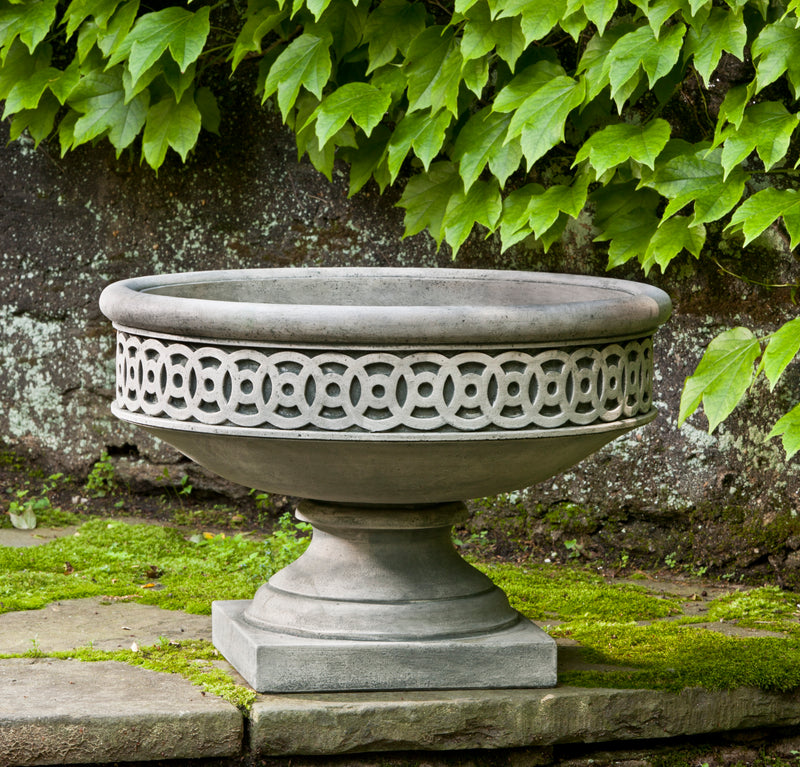 Ornate low urn shown on mossy step