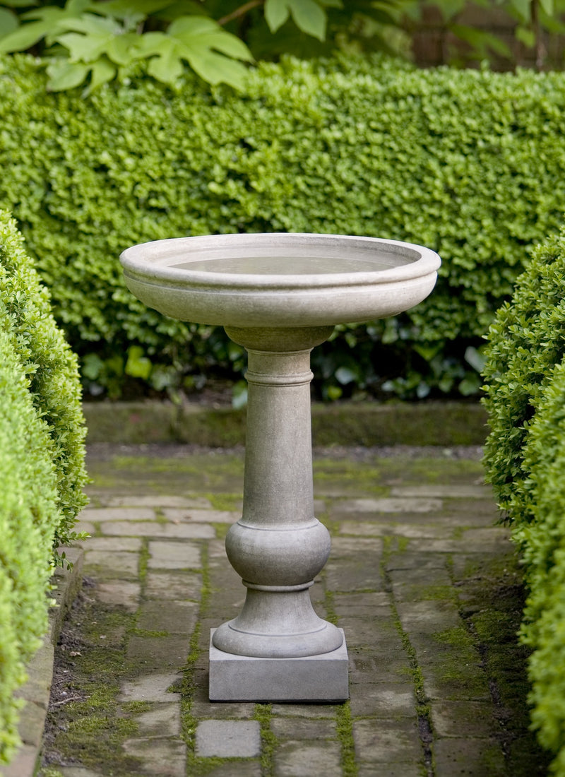 Classic gray birdbath with round bowl and square plinth