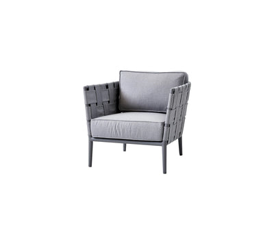 Outdoor light gray woven armchair with matching cushions on white background