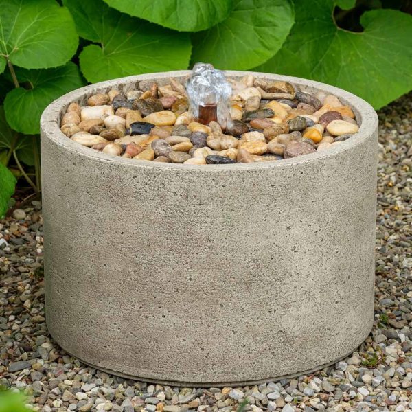 Round fountain with gravel on top part and copper spout pictured on gravel