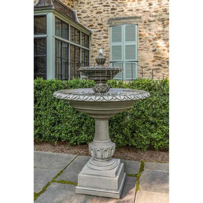 Tiered fountain pictured in front of house with green shutters