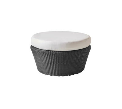 Black woven footstool with white cushion