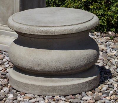 Low round plain pedestal shown on gravel