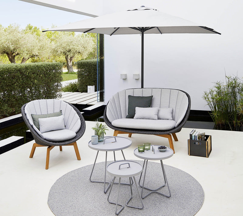 Outdoor furniture set shown with white umbrella