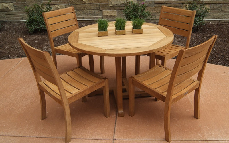 Teak dining set with four chairs shown on reddish patio
