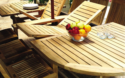 Close up of open extended teak table with bowl of apples