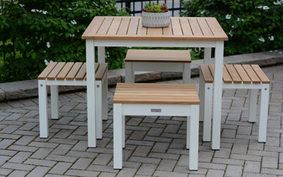 Teak and white metal dining set with four stools on paver patio