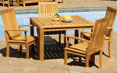 Teak table and four high back chairs shown nest to a pool