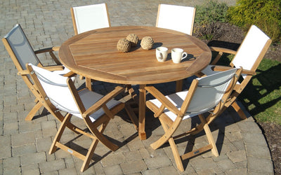 Dining set with one round table and six white chairs shown on paver patio