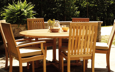Teak dining set shown with yellow tableware on the table