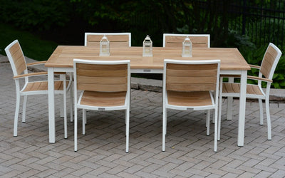 Teak and white metal dining set on paver patio
