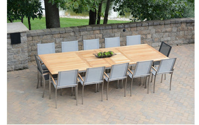Rectangular wooden table with twelve chairs on brick patio 